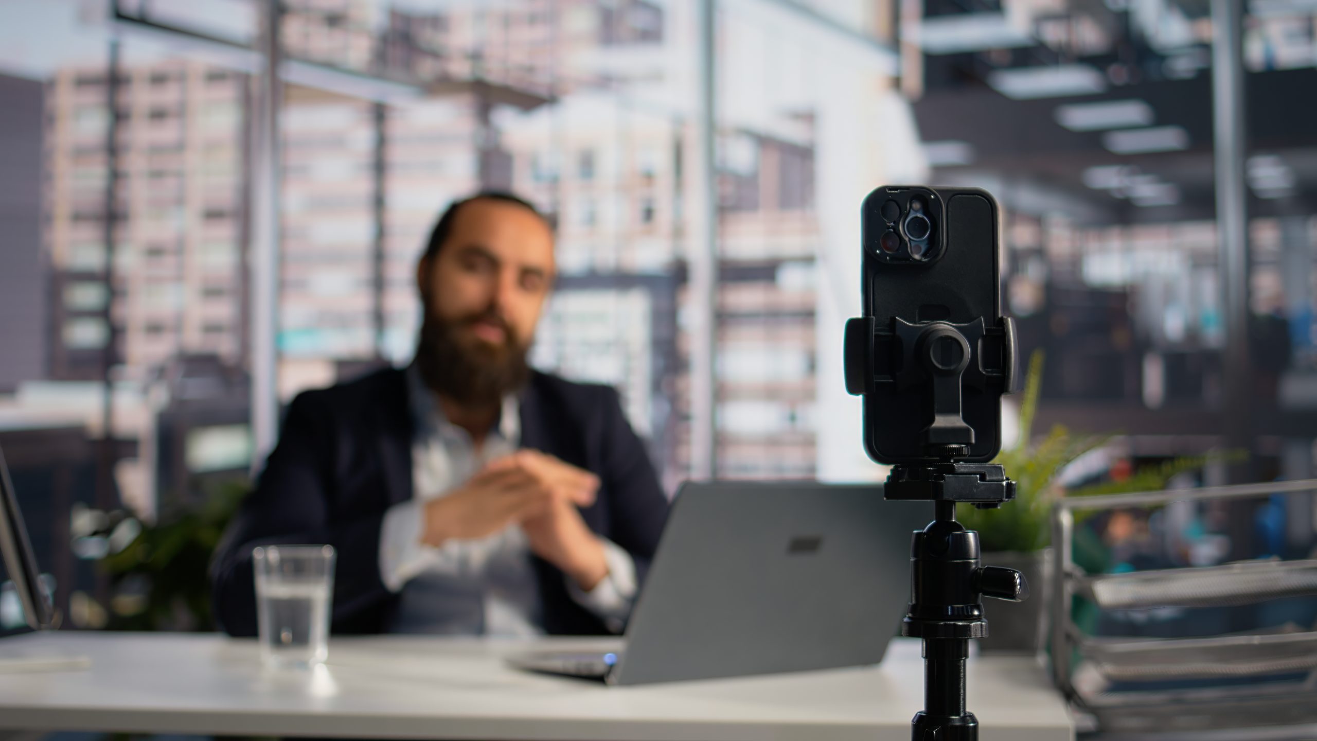 Smartphone on a tripod set up to record video content, representing a law firm's video marketing workflow