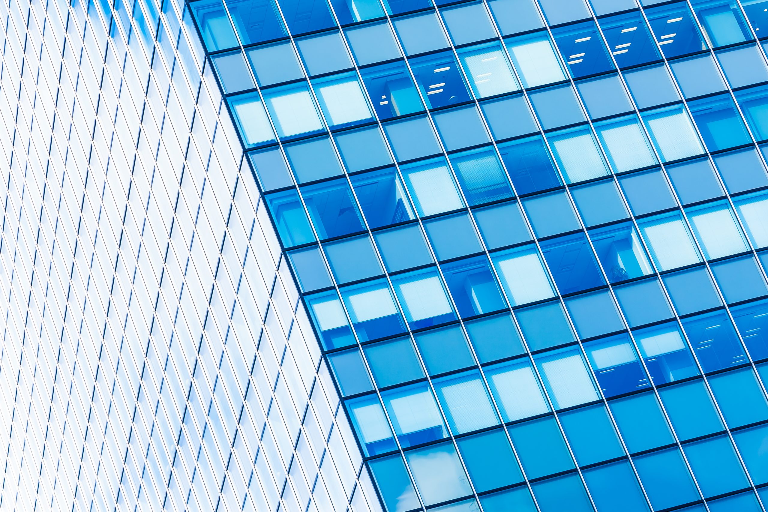 Modern glass office building facade representing transparency in AI-disclosed law firm advertising