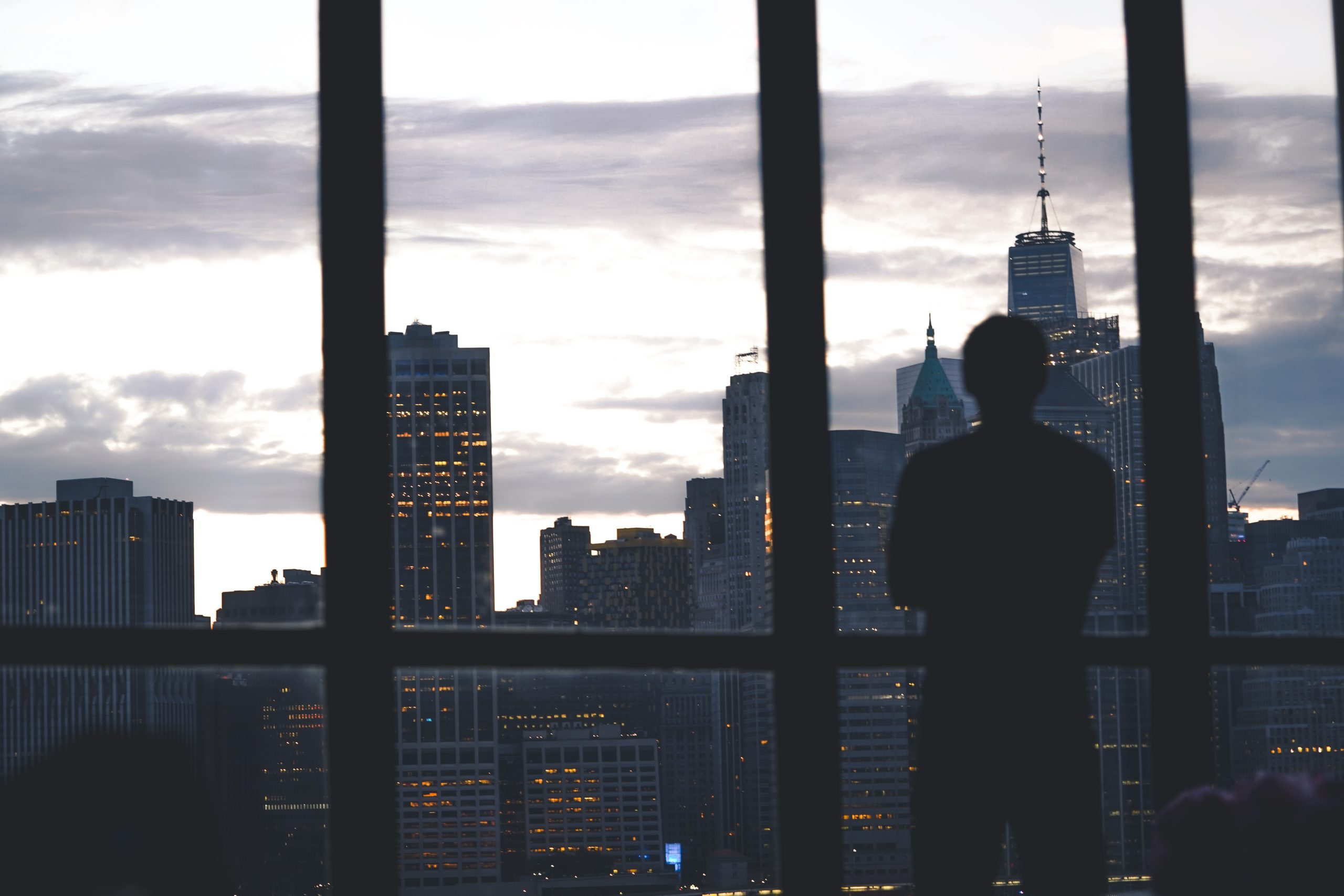 Silhouette of a confident professional overlooking a city skyline, representing an attorney building a personal brand and reputation